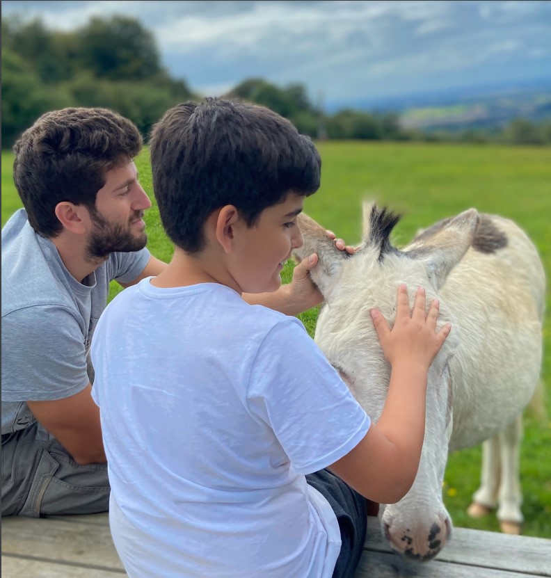 A child and an adult meeting a donkey on a Free to Be Kids break